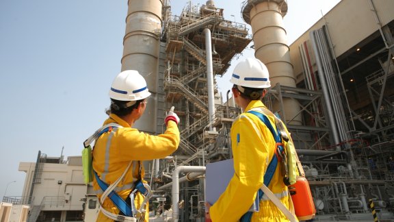Two people in safety gear standing in a project site